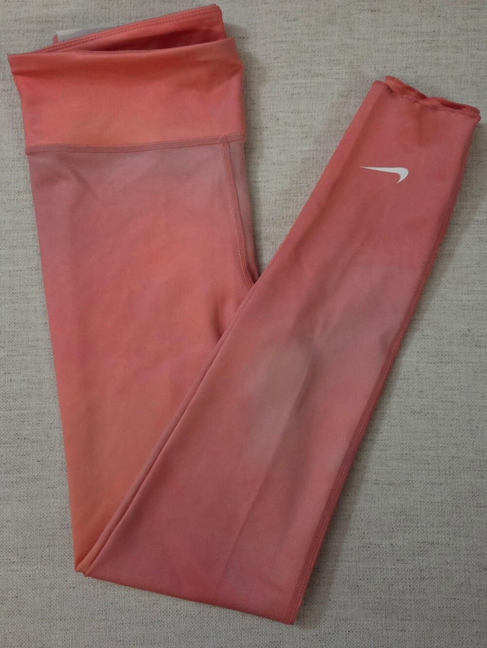 Nike Kids Coral Pink Performance Leggings with White Swoosh. Size Large